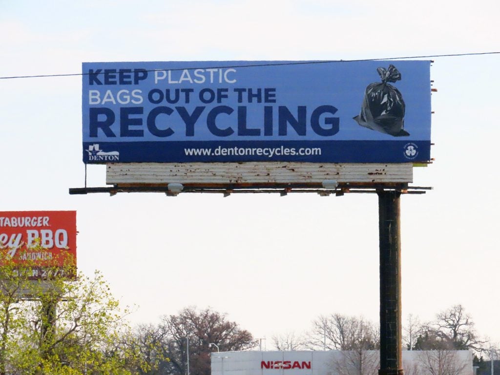 PSA from the city of Denton that says KEEP PLASTIC BAGS OUT OF RECYCLING with an image of a black trash bag next to it.