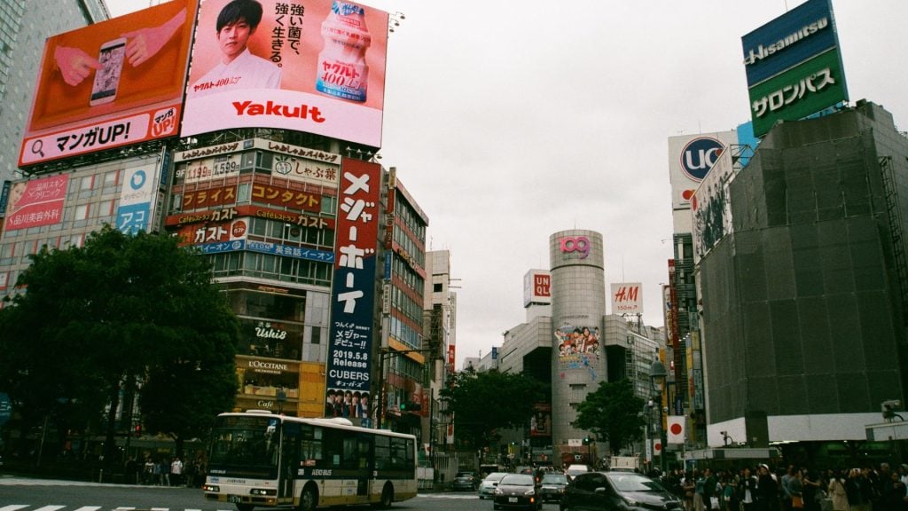 This bustling city scene filled with vibrant billboards demonstrates the power of high-traffic advertising locations. For insurance companies, placing ads in busy urban centers like this can significantly increase insurance sales by reaching commuters, shoppers, and tourists with constant, high-impact visibility.