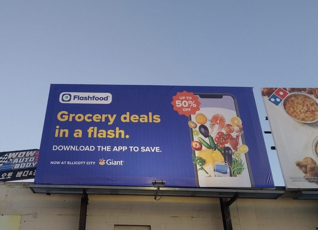 Photo of billboard with mobile app advertisement for grocery store