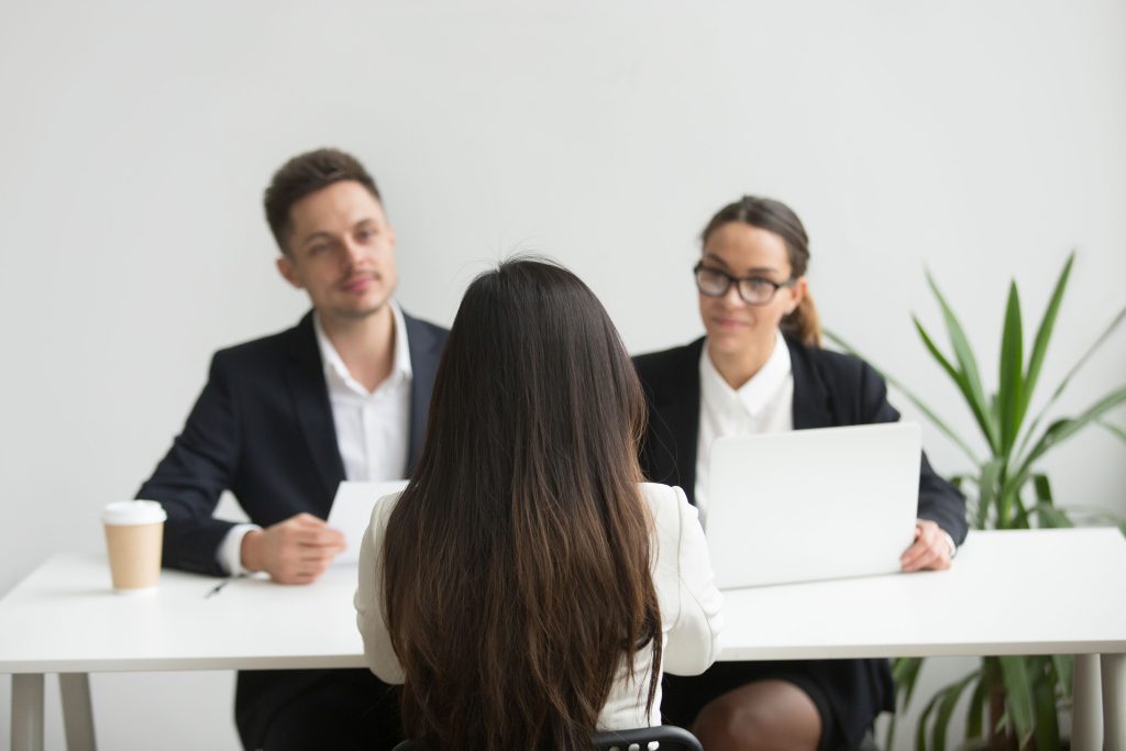 A photo of professionals interviewing a candidate from a marketing position.