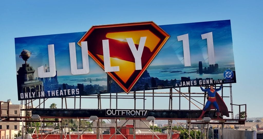 This picture is of a superman movie campaign featuring superman lifting up the promotional billboard.