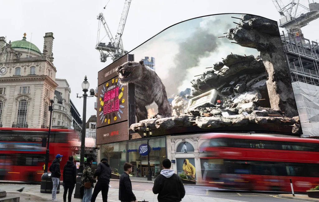 This is a picture of a movie billboard spectacular for Army of the Dead of a 3D zombie tiger coming out of the digital billboard. 