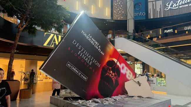 A picture of a movie billboard spectacular for Final Destination that is inside and looks like it fell from the ceiling.