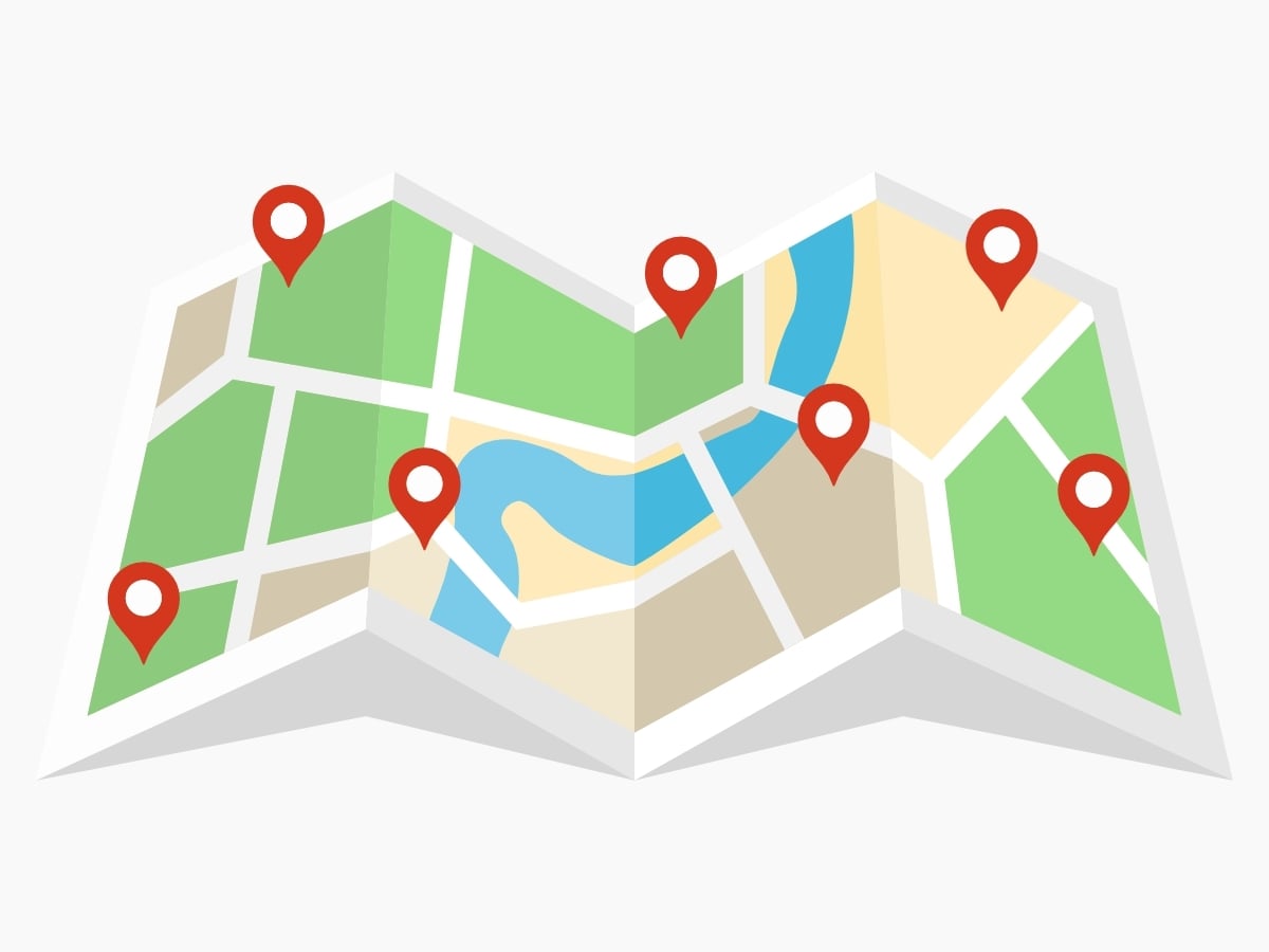 A close-up shot of several colored push pins on a map, symbolizing the specific site selection process for regional multi-location marketing campaigns.
