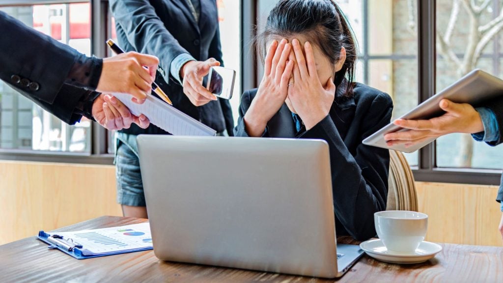 Advertising mistakes illustrated by a stressed marketing professional trying to manage multiple tasks at once, leading to campaign inefficiencies and poor results.