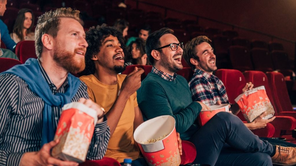 Cinema advertising reaching engaged moviegoers seated in a theater, demonstrating the impact of big-screen brand messaging.
