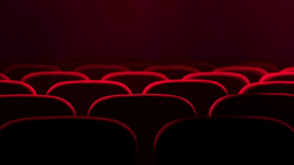 Cinema advertising environment featuring rows of movie theater seats designed for high-attention audience engagement.