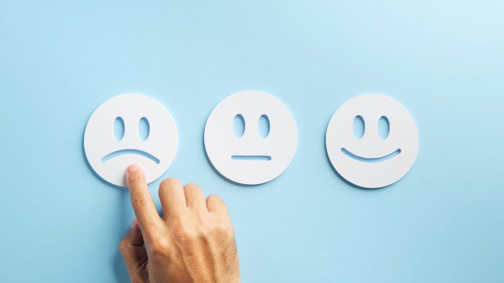Customer selecting a negative feedback icon represents consumer trust and AI challenges related to satisfaction, accuracy, and confidence.