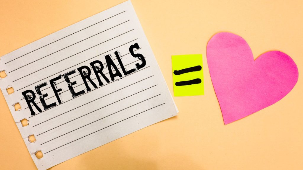 Referral marketing concept with the word referrals and a heart icon, highlighting B2B advertising strategies that encourage customer advocacy and business growth.