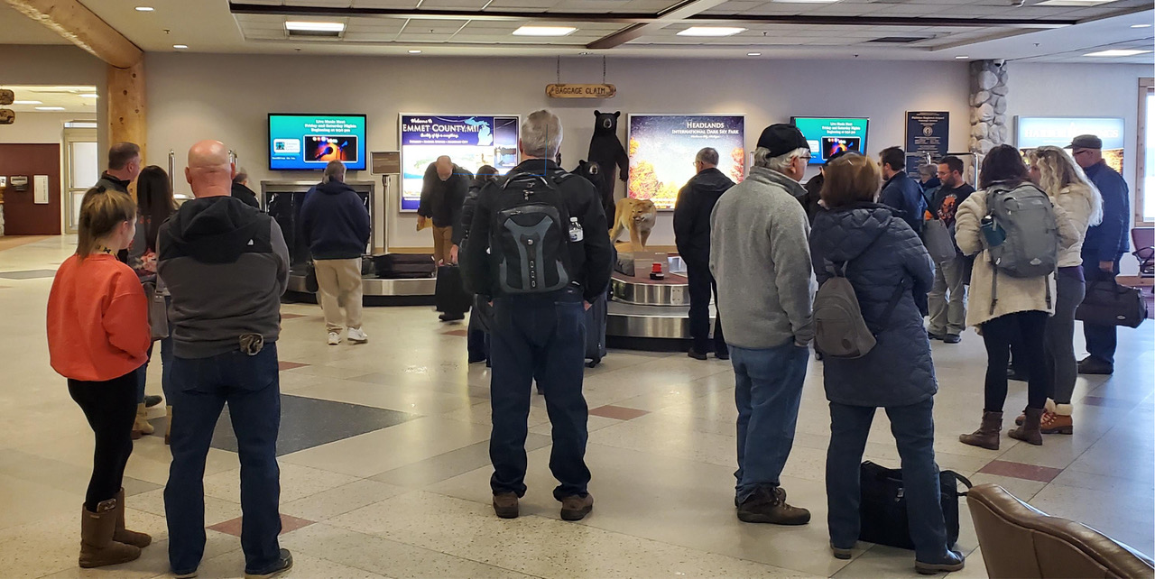 Digital advertising screens at Pellston Regional/Emmet County Airport baggage claim