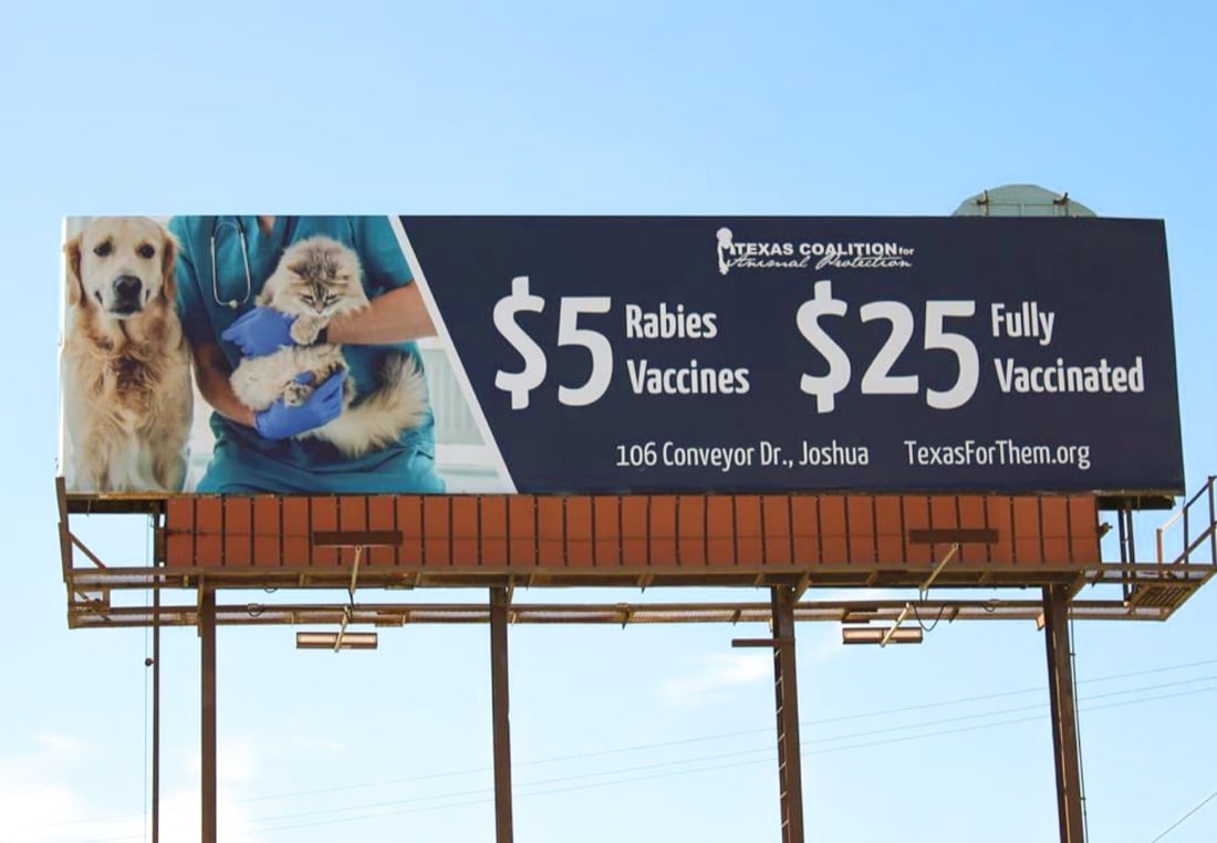 Texas Coalition for Animal Protection billboard offering $5 rabies vaccines, with a dog and a cat
